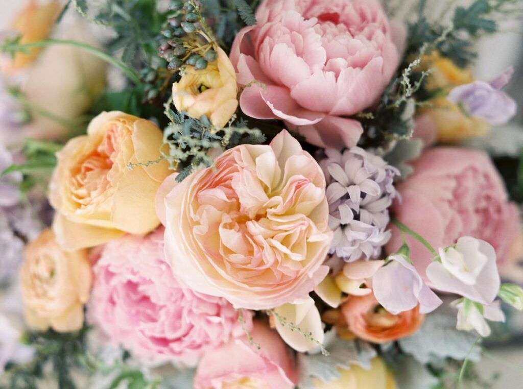 Closeup of a Pastel Colored Wedding Bouquet with Pink and Yellow Flowers