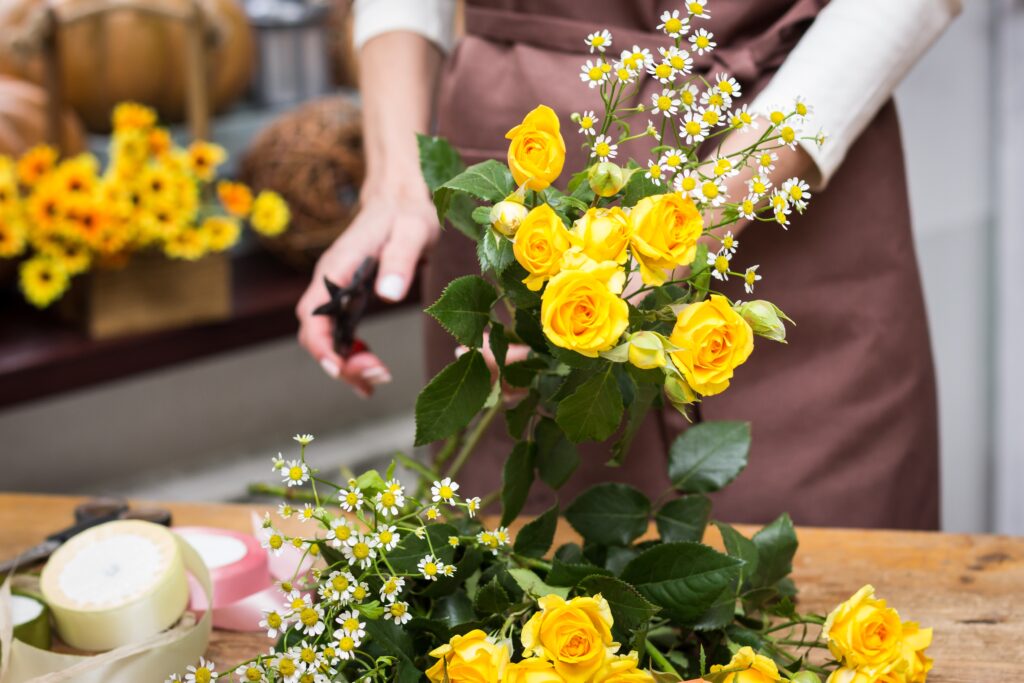 Putting together a yellow flower arrangement