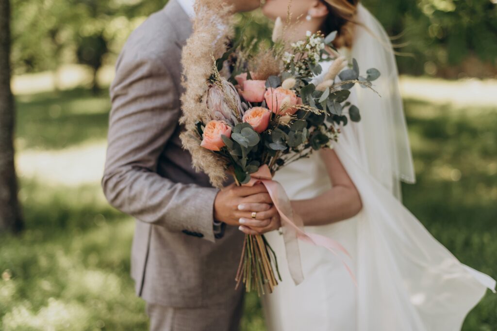 A bouquet in the hands of a couple who is getting married.