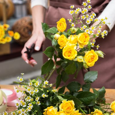 Putting together a yellow flower arrangement